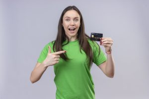 Young Beautiful Girl Wearing Green T Shirt Exited Happy Holding Credit Card Pointing With Finger It Standing Isolated White Background Scaled